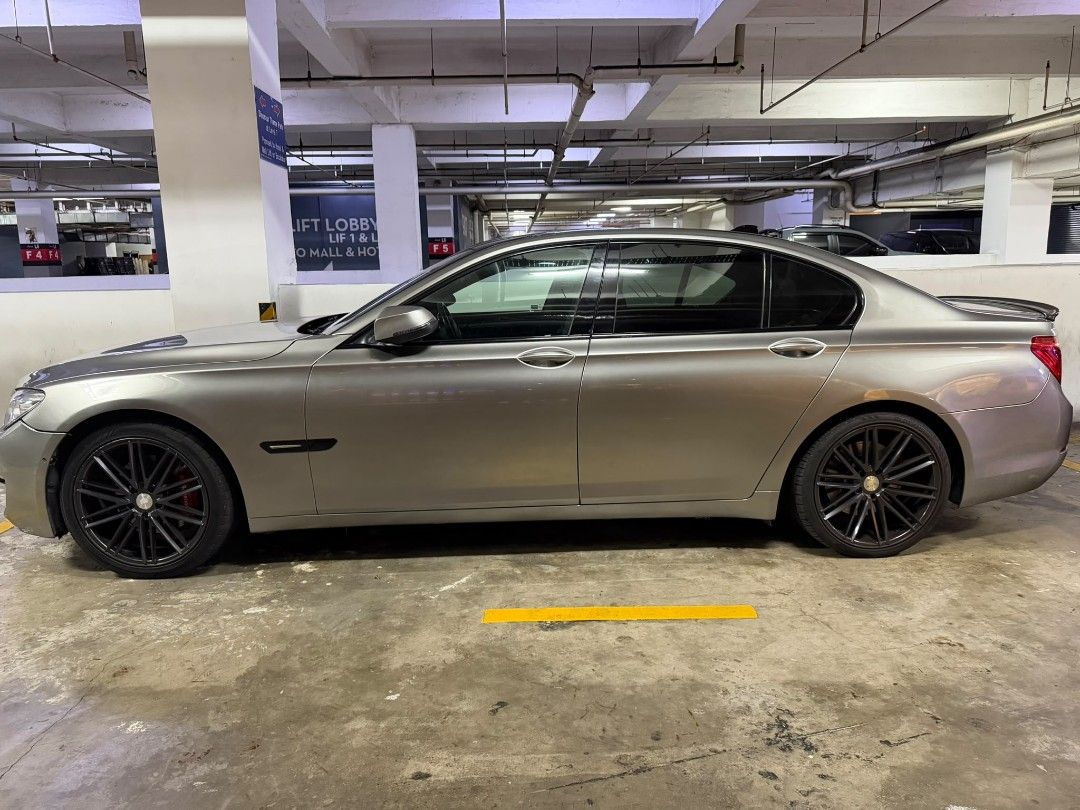 BMW 7 Series 740Li (A) (Category: Used Cars) located in Singapore. Submitted by ferrechan.480 (Listing ID 1445058688, Image 3). Description: Silver BMW 7 Series sedan. Black rims. Tinted windows. Located in a parking garage. Ready for a new owner. Purchased with nothing to repair. receipt upon viewing.