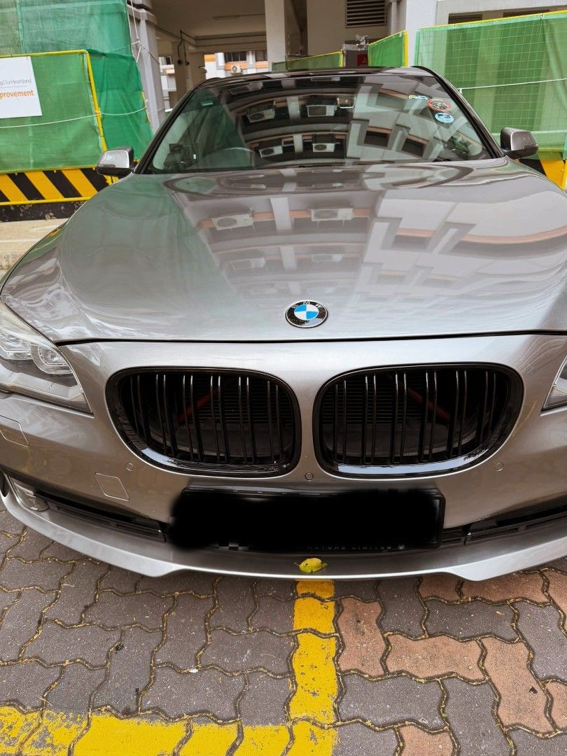 BMW 7 Series 740Li (A) (Category: Used Cars) located in Singapore. Submitted by ferrechan.480 (Listing ID 1445058688, Image 2). Description: Silver BMW 7 Series sedan. Black rims. Tinted windows. Located in a parking garage. Ready for a new owner. Purchased with nothing to repair. receipt upon viewing.