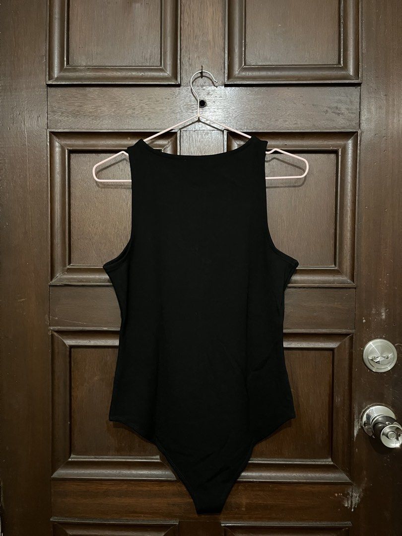 Bodysuit H&M (Category: Sleeveless) located in Makati City. Submitted by yoursecondbest (Listing ID 1467250780, Image 2). Description: - Brand: H&M - Size: Medium (M) - Color: Classic Black - Material: Stretchy ribbed cotton - Features: Front chest zipper, thong bottom with snap closure - Condition: Brand new with clean tag attached - Origin: Made in Vietnam - Style: Versatile piece, easy to pair with denim or skirts.