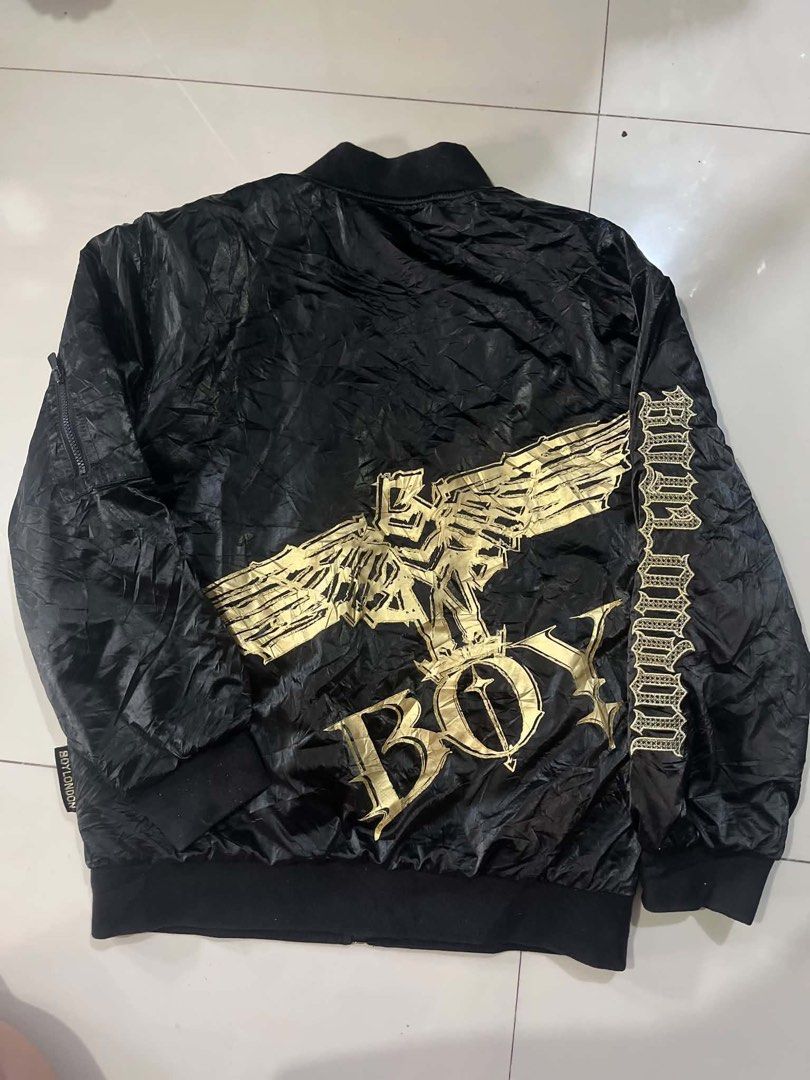 BOY LONDON BOMBER JACKET - BLACK GOLD EDITION (Category: Coats, Jackets and Outerwear) located in Manila. Submitted by silentforest_c1f6e4 (Listing ID 1467342719, Image 2). Description: - Size: Fit S to M Adult / Unisex - Condition: 9/10 - Shrpy pa! Embroidery malinis, zipper goods - Details: Bomber Jacket, Gold Eagle Logo, Embroidered Sleeve, Satin Type - Style: Pang streetwear, pang OOTD, pang concert!.