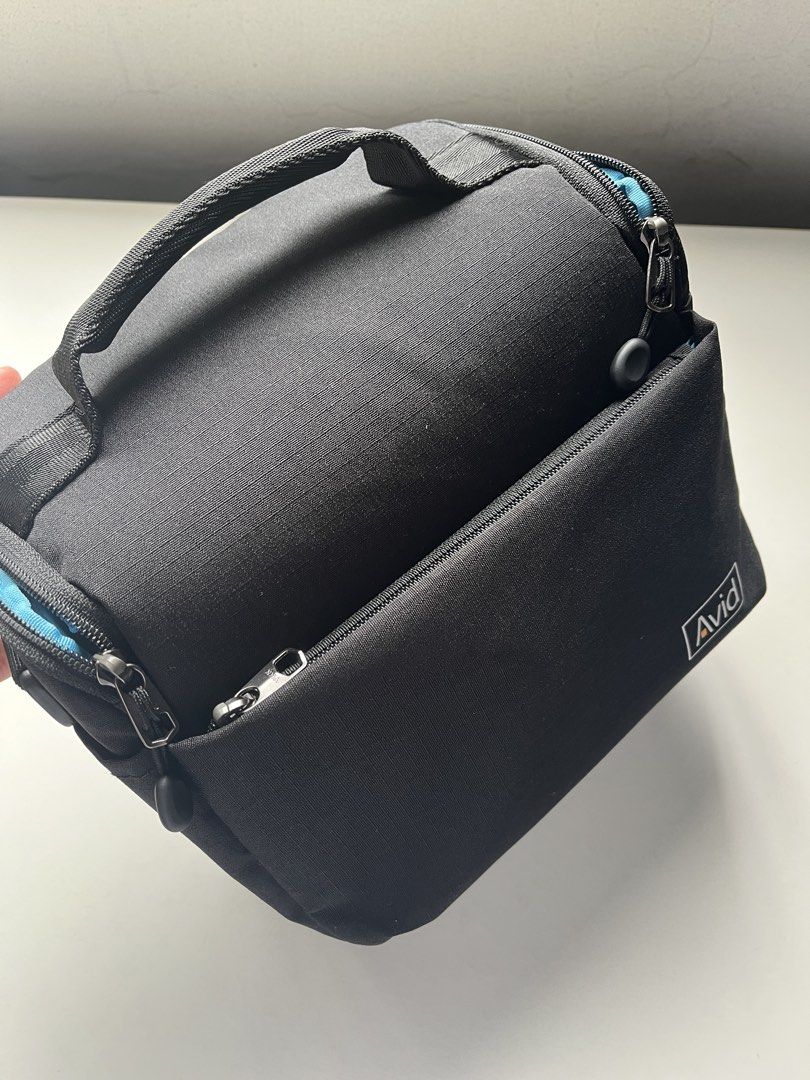 Brand New Avid Black Camera Bag (Category: Camera Bags & Carriers) located in Bacoor. Submitted by shopannerivera (Listing ID 1467232282, Image 3). Description: - Brand: Avid - Color: Black exterior with bright blue interior - Protection: Padded interiors to keep your camera gear secure - Storage: Front zippered pocket for small accessories and memory cards - Portability: Includes a top grab handle and adjustable shoulder strap - Condition: Clean