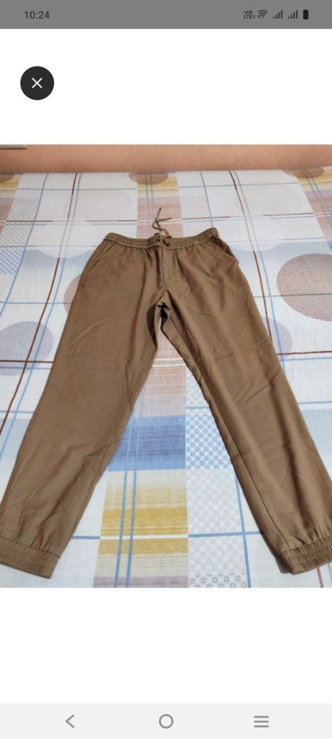 Brown drawstring jogger pants with cuffed hems (Category: Other Bottoms) located in Tabaco. Submitted by kooki24 (Listing ID 1467321257, Image 1). Description: - Color: Brown - Condition: Excellent, clean fabric with no stains or damage - Waist: Elastic waistband with adjustable drawstring - Pockets: Two functional side pockets - Cuffs: Ribbed ankles for a secure fit - Style: Casual everyday wear.