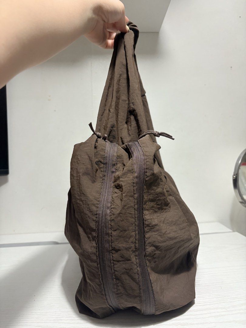 Brown Nylon Slouchy Shoulder Bag (Category: Shoulder Bags) located in Quezon City. Submitted by geminiselection (Listing ID 1467343572, Image 2). Description: 🎀 no brand, brandnew. Hindi pa nagagamit 🦋 super spacious and madami pockets, kasya 14 inches laptop. May lalagyan ng tumbler sa gilid 🩵 hobo bag, double lining. .