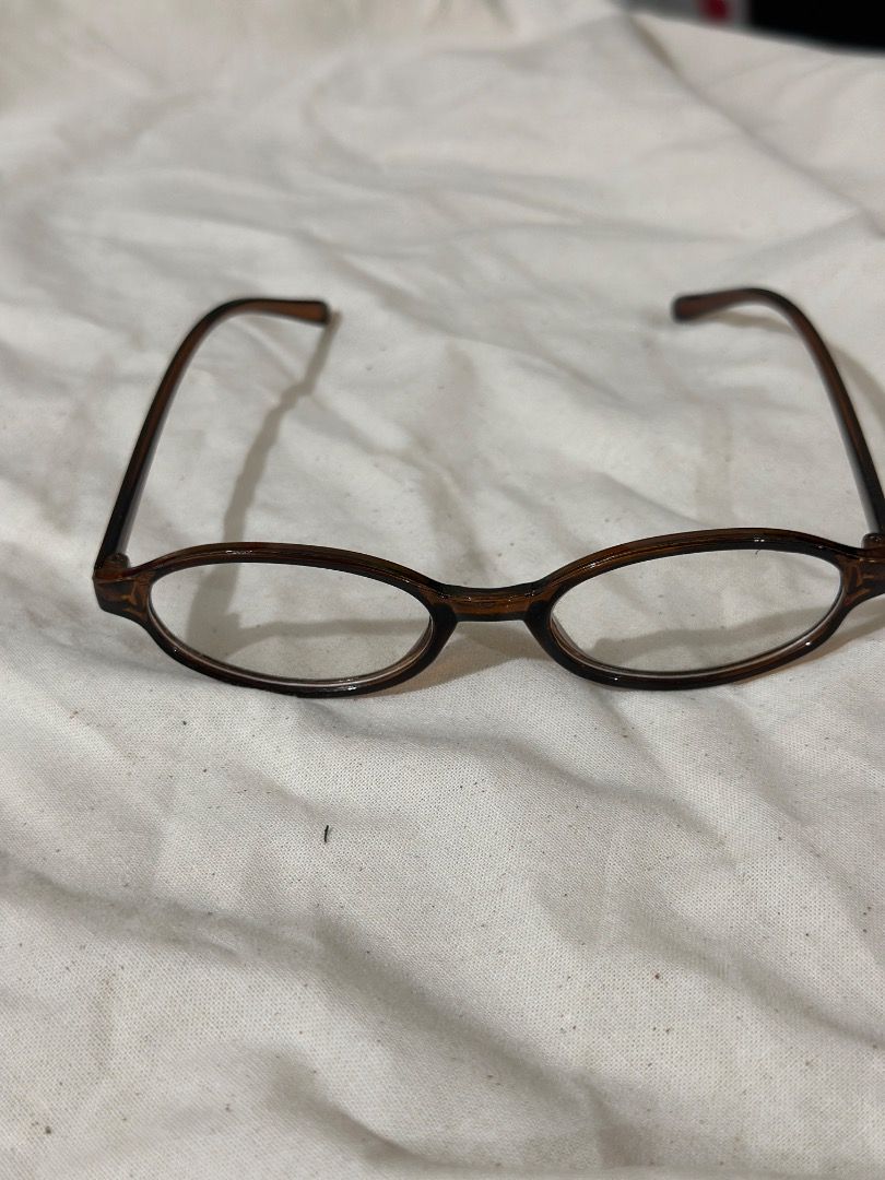 Brown Oval Frame Glasses Reading Glasses (Category: Sunglasses & Eyewear) located in Mandaluyong City. Submitted by lovedbyjaaaam (Listing ID 1467279889, Image 3). Description: - Style: Brown oval frames with a stylish tortoise-style pattern - Lenses: Clear, clean condition with no major scratches - Comfort: Lightweight build with comfortable temples for all-day wear - Fit: Standard fit, perfect for daily use or blue light blocking.