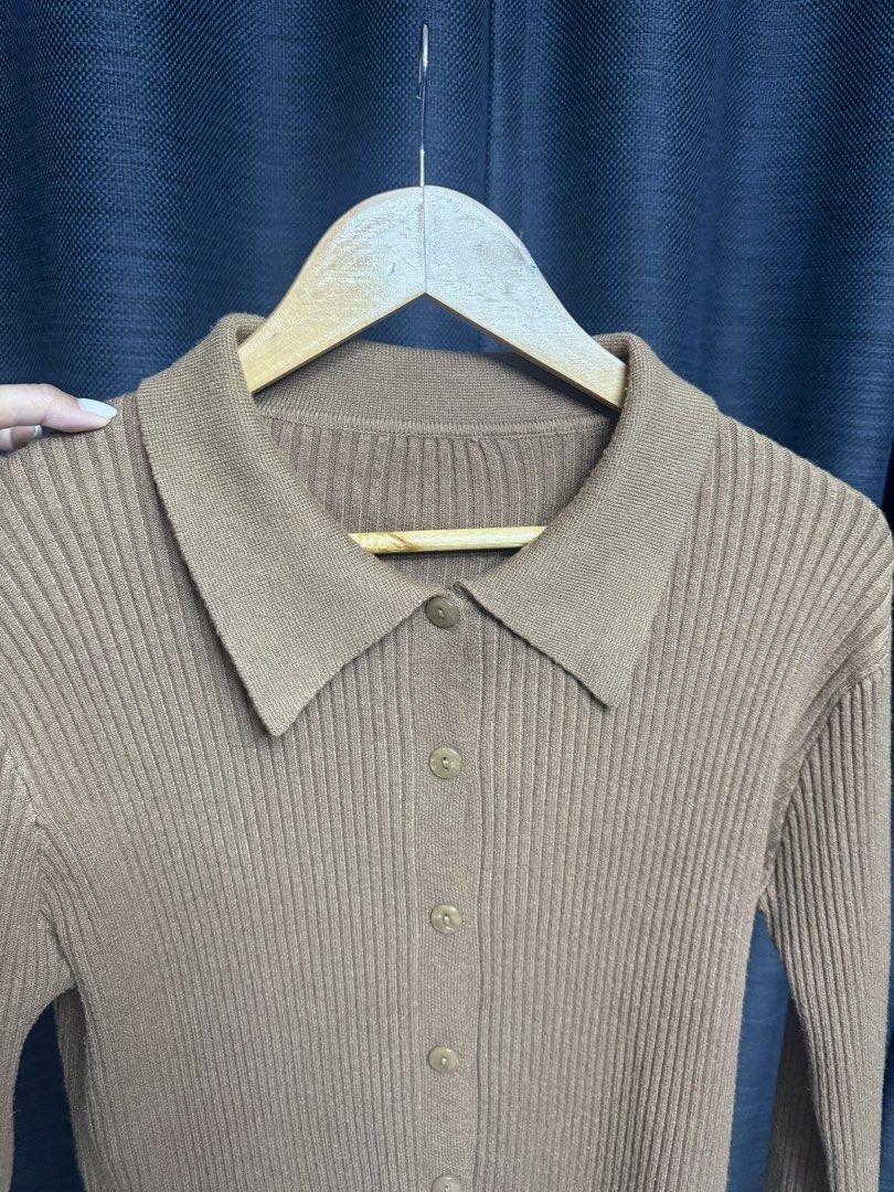Brown Ribbed Knit Cardigan with Collar (Category: Coats, Jackets and Outerwear) located in Quezon City. Submitted by euniceescalada9 (Listing ID 1467198388, Image 3). Description: - Color: Brown neutral tone - Style: Fitted silhouette with classic collar and front buttons - Material: Soft ribbed knit texture - Features: Long sleeves, easy to layer or wear on its own - Condition: Good staple piece for cooler weather.