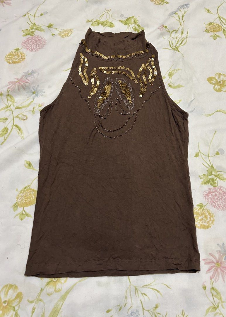 Brown Sequin Embellished Mock Neck Tank Top (Category: Sleeveless) located in Kawit. Submitted by collectedbyaml (Listing ID 1466903207, Image 1). Description: - Color: Brown - Style: Sleeveless mock neck top - Design: Intricate gold and silver sequin pattern around the collar and chest - Fabric: Lightweight and stretchy for a comfortable fit - Versatility: Easy to dress up for a night out or keep casual with jeans.