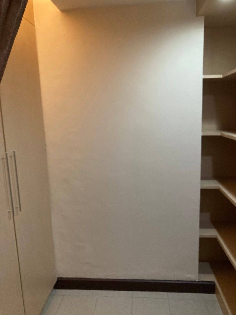 BSA Twin Tower Condominium (Category: Apartments & Condos) located in Muntinlupa City. Submitted by lazoftoys (Listing ID 1467256002, Image 3). Description: - Twin bed studio unit, ready to move in - Private bathroom with glass shower enclosure - Built-in kitchenette with microwave and refrigerator - TV setup and air conditioning installed - Ample overhead storage cabinets and wardrobe space - Sleek, modern, and well-maintained finish.