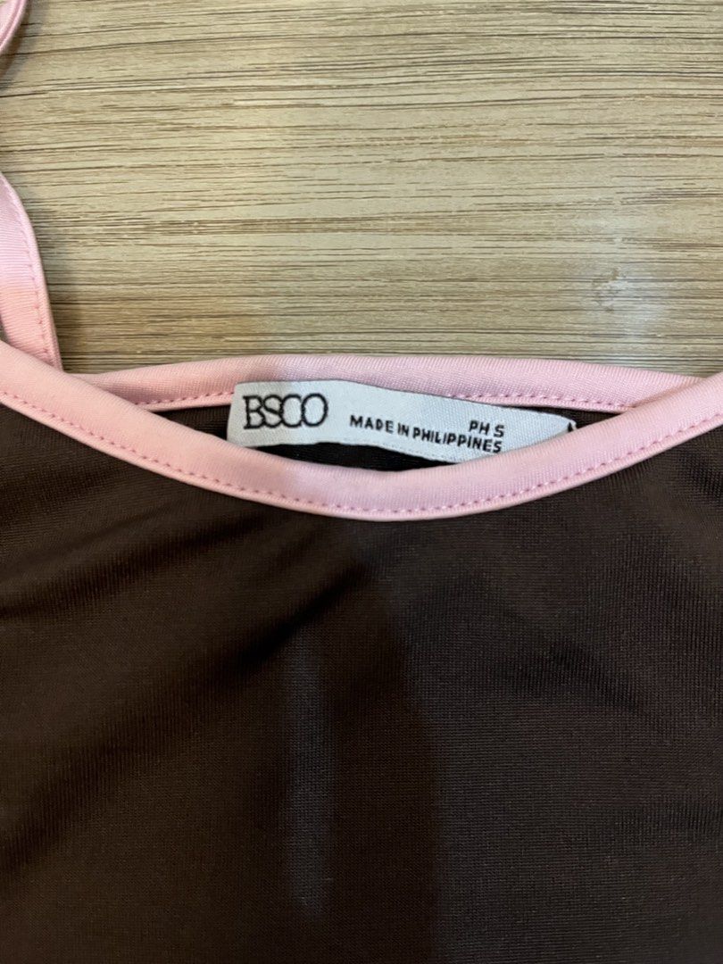 BSCO Brown Pink Trim Camisole Top (Category: Sleeveless) located in Quezon City. Submitted by yours.myaa (Listing ID 1467314870, Image 2). Description: - Brand: BSCO (Made in the Philippines) - Size: PH Small - Color: Brown with contrast pink trim & thin straps - Neckline: Scoop neck - Fabric: Soft, stretchy, and comfortable - Styling: Great for casual wear, easily matches jeans or skirts.