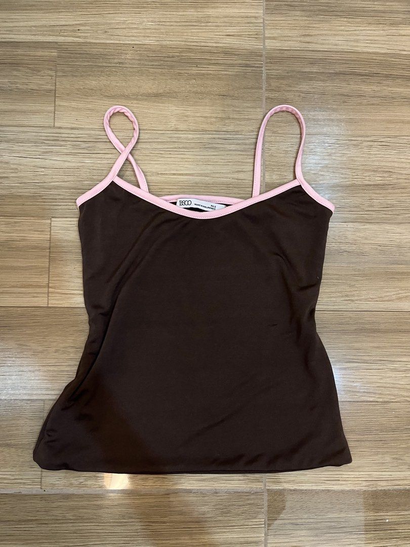 BSCO Brown Pink Trim Camisole Top (Category: Sleeveless) located in Quezon City. Submitted by yours.myaa (Listing ID 1467314870, Image 1). Description: - Brand: BSCO (Made in the Philippines) - Size: PH Small - Color: Brown with contrast pink trim & thin straps - Neckline: Scoop neck - Fabric: Soft, stretchy, and comfortable - Styling: Great for casual wear, easily matches jeans or skirts.