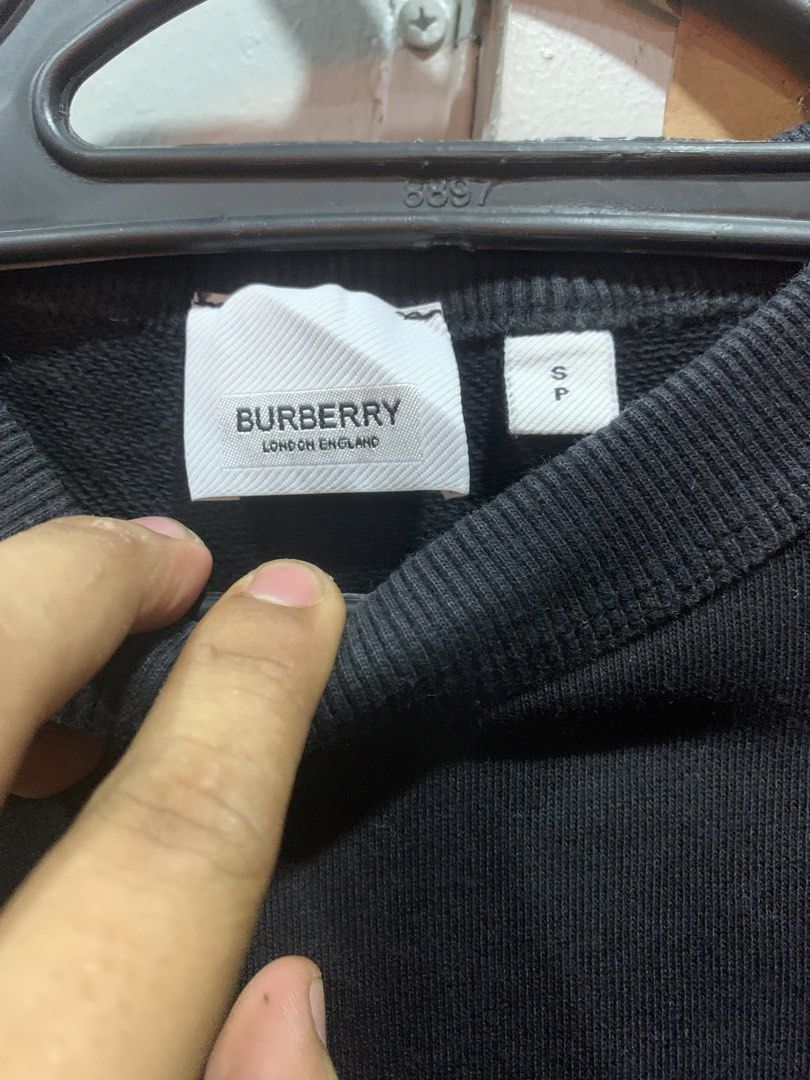 Burberry Black Crystal Logo Sweatshirt (Category: Luxury Apparel) located in Cagayan de Oro. Submitted by agboysalis60090 (Listing ID 1467338796, Image 3). Description: Black crewneck sweatshirt from Burberry London England. Made in Portugal. 100 percent cotton body with elastane blend ribbing. Size small tag attached. Small embroidered lettering on the chest. Large crystal rhinestone monogram logo graphic on the back. Long sleeves with ribbed cu