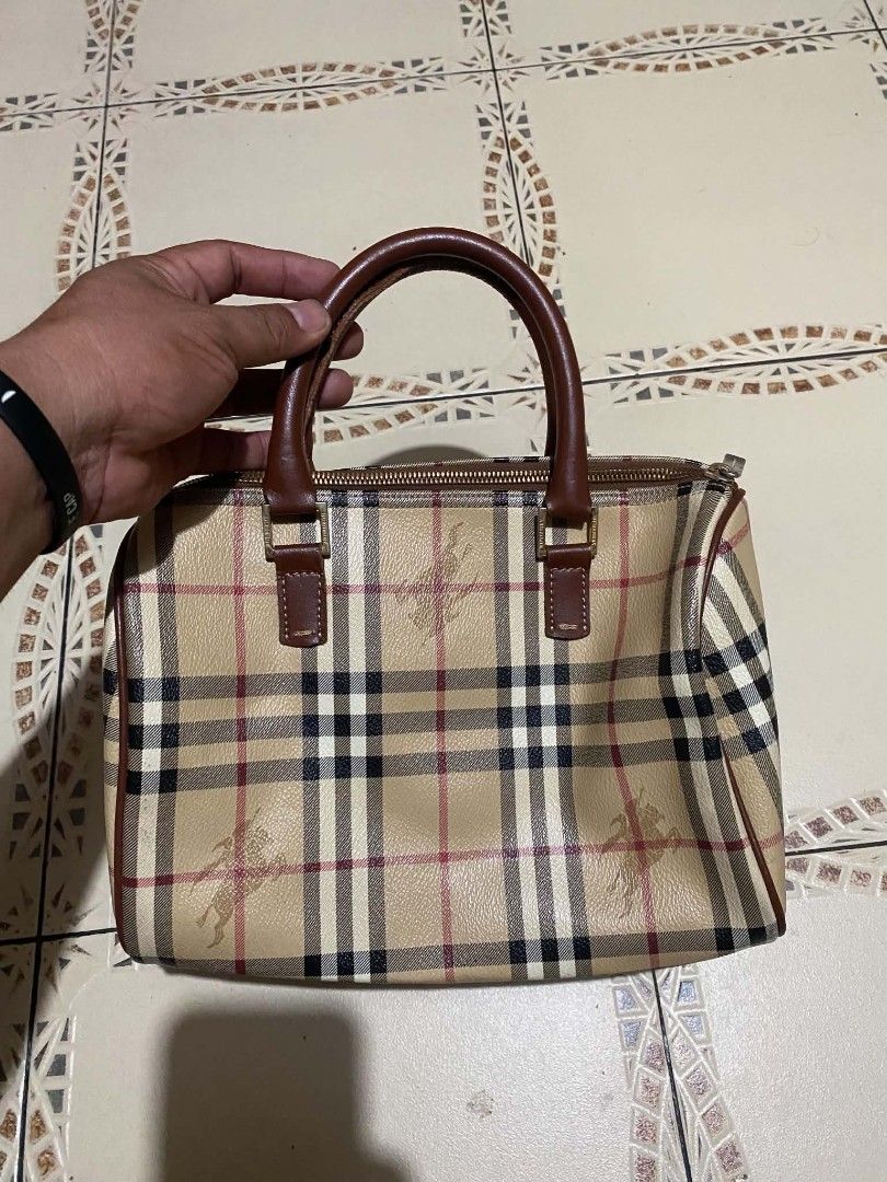 Burberry Vintage Nova Check Barrel Handbag (Category: Luxury Bags & Wallets) located in Cebu City. Submitted by tlisurplus (Listing ID 1467274363, Image 1). Description: - Authentic Burberry barrel handbag in iconic beige Nova check canvas - Features durable brown leather top handles and trim - Secure top zip closure with branded metal pull - Clean dark fabric interior with convenient inner slip pocket and leather tag - Compact size, ideal for da