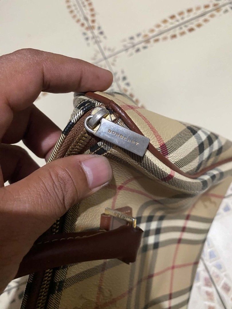 Burberry Vintage Nova Check Barrel Handbag (Category: Luxury Bags & Wallets) located in Cebu City. Submitted by tlisurplus (Listing ID 1467274363, Image 3). Description: - Authentic Burberry barrel handbag in iconic beige Nova check canvas - Features durable brown leather top handles and trim - Secure top zip closure with branded metal pull - Clean dark fabric interior with convenient inner slip pocket and leather tag - Compact size, ideal for da