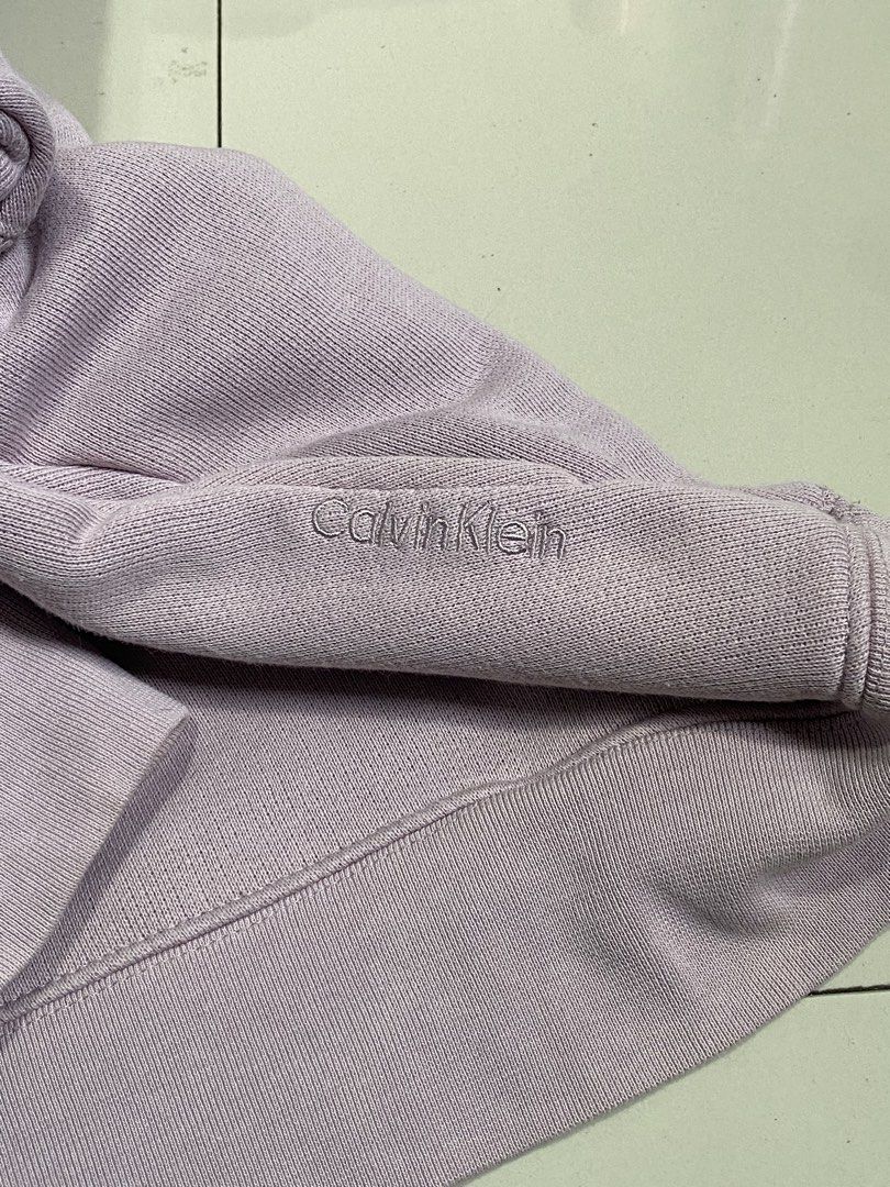 Calvin Klein Purple Sweatshirt Size M (Category: Coats, Jackets and Outerwear) located in Baguio. Submitted by yunothewizardking (Listing ID 1467362558, Image 3). Description: - Brand: Calvin Klein - Color: Dusty Purple - Size: Medium (Regular fit) - Material: Comfortable cotton and polyester blend with warm fleece lining - Details: Embroidered logo lettering on the sleeve, classic collar inset, and ribbed cuffs and hem - Perfect for casual styli