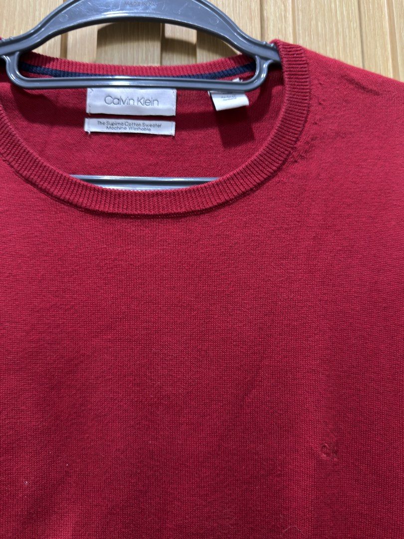 Calvin Klein Red Supima Cotton Sweater (Category: Coats, Jackets and Outerwear) located in Bacoor. Submitted by preloved_with_love_ (Listing ID 1467192781, Image 2). Description: Dimension: W 20in L 29in - Brand: Calvin Klein - Color: Dark Red - Size: Medium (True to size) - Material: 100% Supima cotton (lightweight and super soft) - Design: Long sleeves, ribbed cuffs and hem, subtle tonal embroidered CK logo on chest - Care: Machine washable - C