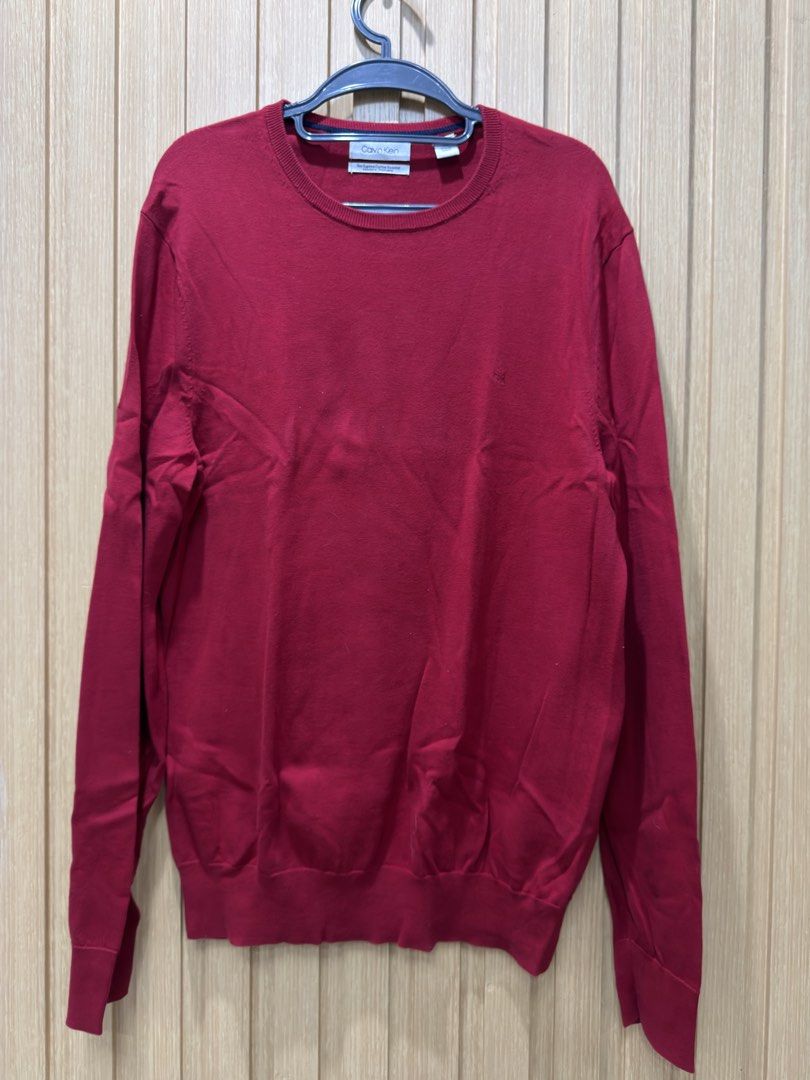 Calvin Klein Red Supima Cotton Sweater (Category: Coats, Jackets and Outerwear) located in Bacoor. Submitted by preloved_with_love_ (Listing ID 1467192781, Image 1). Description: Dimension: W 20in L 29in - Brand: Calvin Klein - Color: Dark Red - Size: Medium (True to size) - Material: 100% Supima cotton (lightweight and super soft) - Design: Long sleeves, ribbed cuffs and hem, subtle tonal embroidered CK logo on chest - Care: Machine washable - C