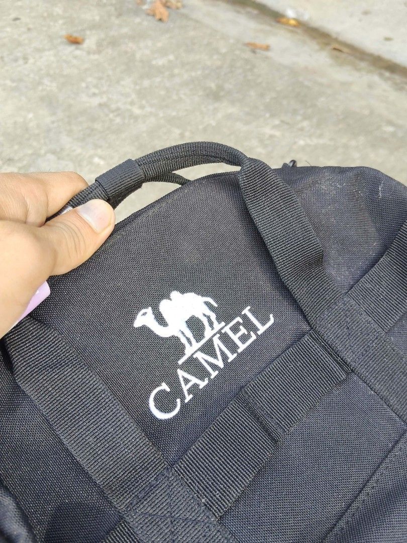 Camel Black Crossbody Duffel Bag (Category: Cross-body Bags) located in Lucena. Submitted by ziboldawg (Listing ID 1467347029, Image 1). Description: Black Camel duffel crossbody bag. Small size, measuring roughly 270mm. Dual top grab handles plus an adjustable shoulder strap. White Camel logo printed prominently on the front. Durable fabric construction with interior tag labels intact. Great compact shape for daily outings, gym trips, or quick t