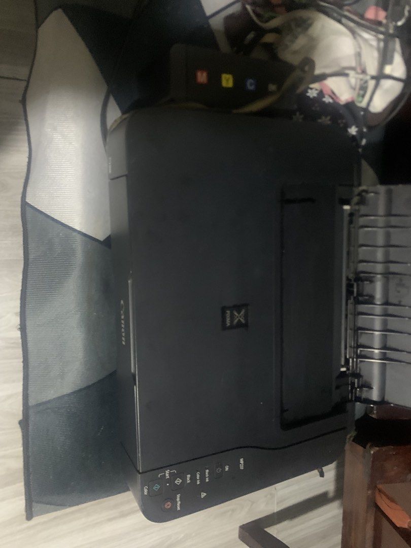 Canon PIXMA MP237 Printer with Ink Tank (Category: Printers, Scanners & Copiers) located in Mandaluyong City. Submitted by quickmountain.780662 (Listing ID 1467260794, Image 2). Description: - Model: Canon PIXMA MP237 All-in-One Printer - Functions: Print, copy, and scan with a built-in flatbed scanner - Ink System: Equipped with an external CISS ink tank for heavy-duty, low-cost printing - Inclusions: Complete set of refill bottles (Black, Cyan,