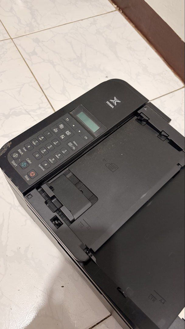 Canon PIXMA Multifunction Printer (Category: Printers, Scanners & Copiers) located in Manila. Submitted by clairerdel08957 (Listing ID 1467324209, Image 1). Description: - Brand: Canon PIXMA Printer - Color: Black - Features: Built-in keypad, small display screen, and adjustable paper tray for LTR and A4 sizes - Condition: Dusty from storage, needs a good wipe down (Power cord not included) - Ideal for: Home printing and scanning tasks.