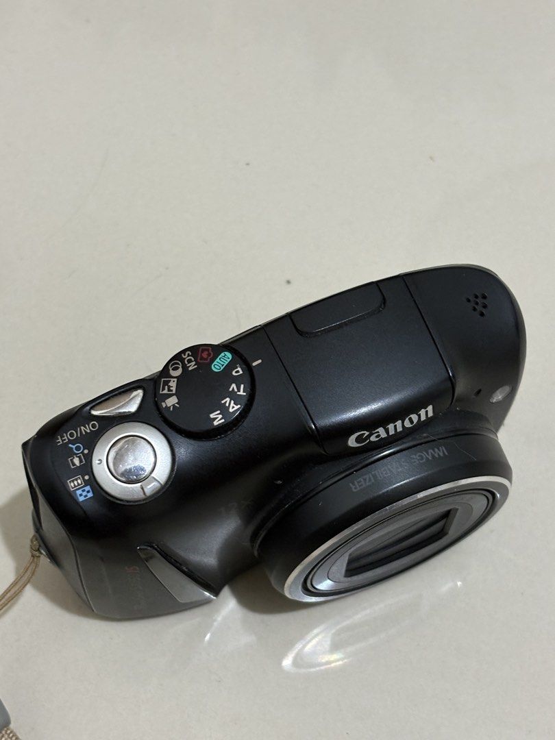 Canon PowerShot SX150 IS Digital Camera (Category: Cameras) located in Manila. Submitted by nicoleannejns (Listing ID 1467356045, Image 2). Description: - Model: Canon PowerShot SX150 IS (Black) - Resolution: 14.1 Megapixels with 12x Optical Zoom - Condition: Tested and works perfectly - Power: Uses standard AA batteries - Inclusions: Eveready battery charger, 2 rechargeable batteries, camera pouch, and attached wrist strap - Perfect for: Everyda