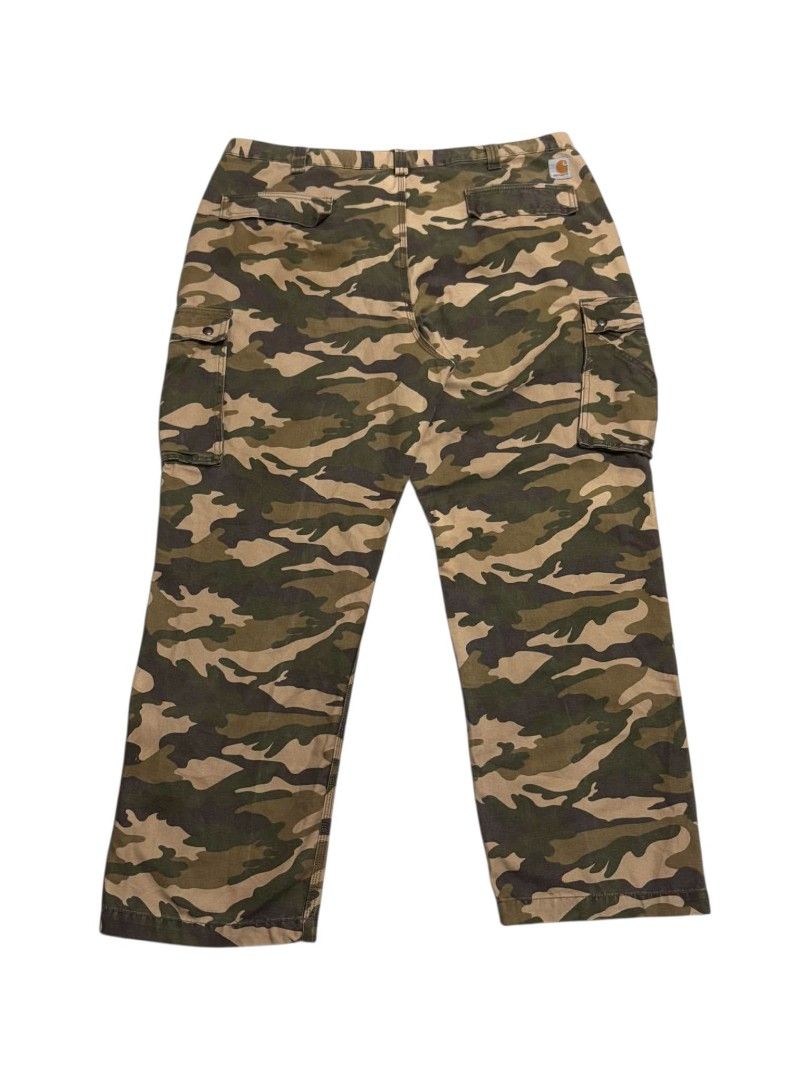 Carhartt Camouflage Cargo Pants (Category: Jeans) located in Bauan. Submitted by onetwothrift2 (Listing ID 1467221319, Image 2). Description: Carhartt Camou Cargo Pants Waist: 44-45 Length: 44.5 Leg opening: 10 Color rate: 9.5/10 Excellent condition No issue.