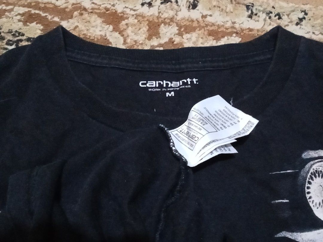 Carhartt WIP Script Escape T-Shirt Black Size M (Category: Tshirts & Polo Shirts ) located in Manila. Submitted by okellorrai95403 (Listing ID 1467231561, Image 3). Description: - Brand: Carhartt WIP - Color: Black - Size: Medium (Measures 20" x 28") - Design: Large front logo, 'Exquisite, Escape' text, and wheel graphic - Material: 100% cotton - Details: Includes neck tag and woven hem label - Condition: Clean, excellent overall condition.