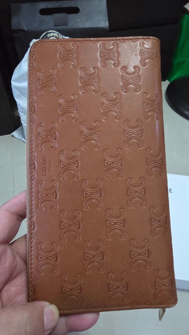 Celine Large Zipped Wallet Tan Triomphe Embossed (Category: Wallets & Card holders) located in Mandaluyong City. Submitted by frse11 (Listing ID 1467215283, Image 1). Description: - Like new Celine Triomphe wallet in classic tan leather - Features an all-over embossed monogram pattern and smooth gold-tone hardware - Secure zip-around closure for daily organization - Comes complete with the original white Celine box, dust bag, and shipping box - P