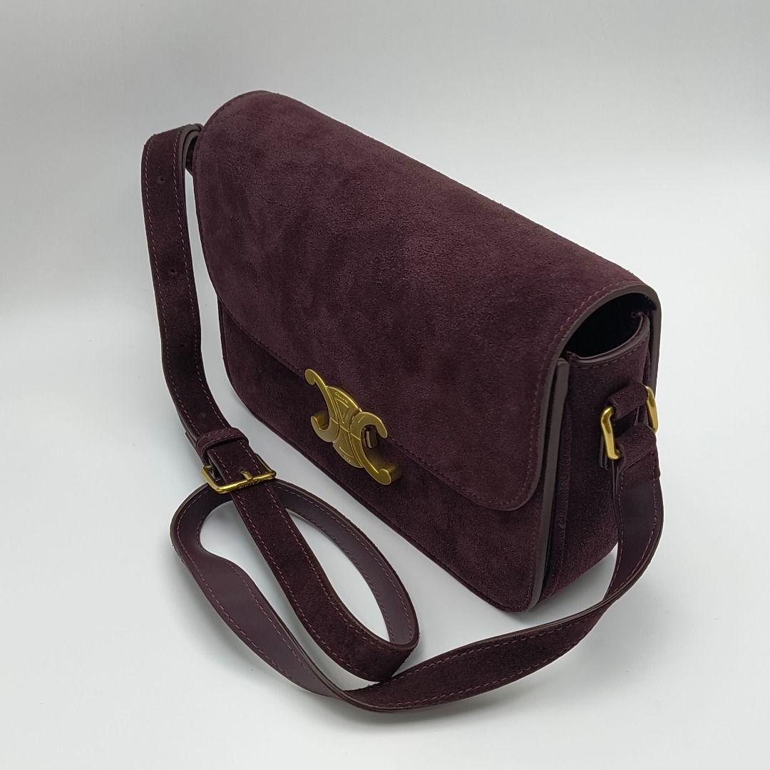Celine Triomphe Bag Medium Burgundy Suede (Category: Luxury Bags & Wallets) located in Cebu City. Submitted by affordabagss (Listing ID 1467353277, Image 2). Description: Celine Classique Triomphe Medium bag crafted in deep burgundy suede calfskin with smooth leather trim and gold-tone hardware. Features the signature Triomphe metal clasp, curved flap, adjustable leather shoulder strap and structured rectangular silhouette. Finished with a leathe