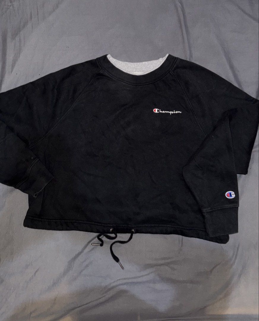 Champion Black Cropped Drawstring Sweatshirt (Category: Coats, Jackets and Outerwear) located in Andop. Submitted by nobleangel (Listing ID 1467309861, Image 1). Description: - Authentic Black Champion sweatshirt - Size: Medium (USA, CA, MEX) / Large (Asia) - Features contrast gray inner collar trim - Embroidered script logo on chest and classic C patch on left sleeve - Adjustable drawstring hem with metal aglets - Comfortable raglan sleeves - Ma