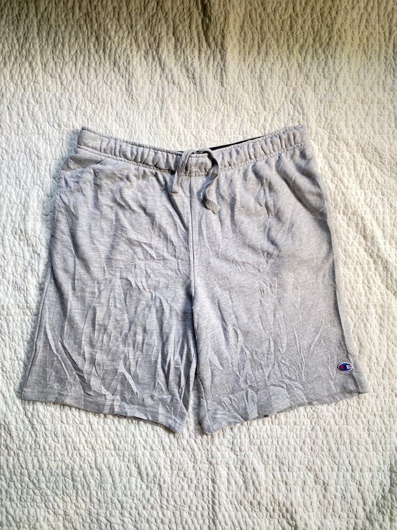Champion Gray Sweatshorts Size L (Category: Shorts) located in Iloilo. Submitted by chapxythriftshop (Listing ID 1467195309, Image 1). Description: - Brand: Champion - Color: Heather Gray - Size: Large - Material: Soft fleece interior lining (Made in Pakistan) - Waistband: Elastic with printed branding and adjustable drawstring - Pockets: Two side pockets and one right back pocket - Branding: Small embroidered Champion logo patch on the lower lef