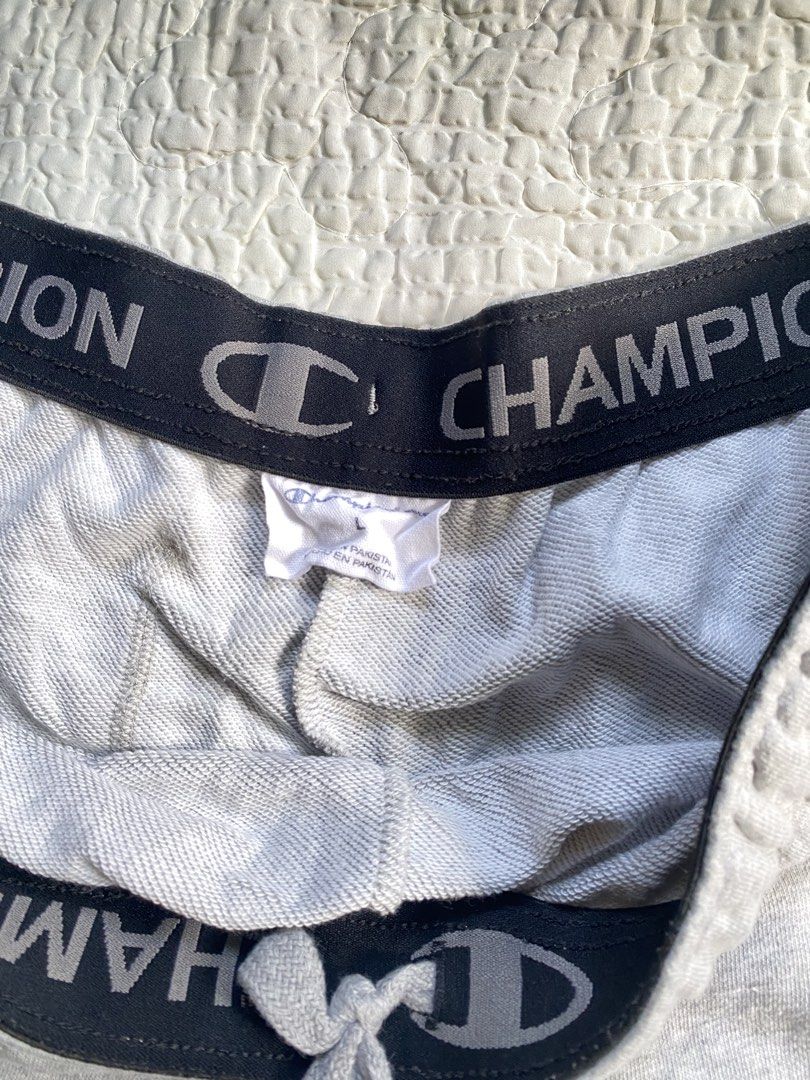 Champion Gray Sweatshorts Size L (Category: Shorts) located in Iloilo. Submitted by chapxythriftshop (Listing ID 1467195309, Image 3). Description: - Brand: Champion - Color: Heather Gray - Size: Large - Material: Soft fleece interior lining (Made in Pakistan) - Waistband: Elastic with printed branding and adjustable drawstring - Pockets: Two side pockets and one right back pocket - Branding: Small embroidered Champion logo patch on the lower lef