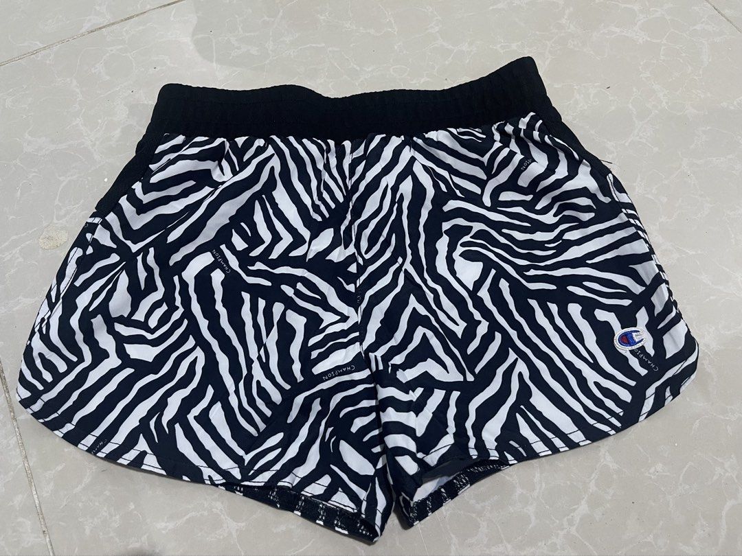 Champion Zebra Print Athletic Shorts (Category: Shorts) located in Cabanatuan. Submitted by imported2023 (Listing ID 1467317972, Image 1). Description: - Brand: Champion - Design: Bold black and white zebra pattern - Waistband: Wide black elastic for a secure and comfortable fit - Details: Iconic embroidered Champion logo patch on the lower left leg - Lining: Built-in white inner brief lining - Material: Lightweight fabric, ideal for running, wor
