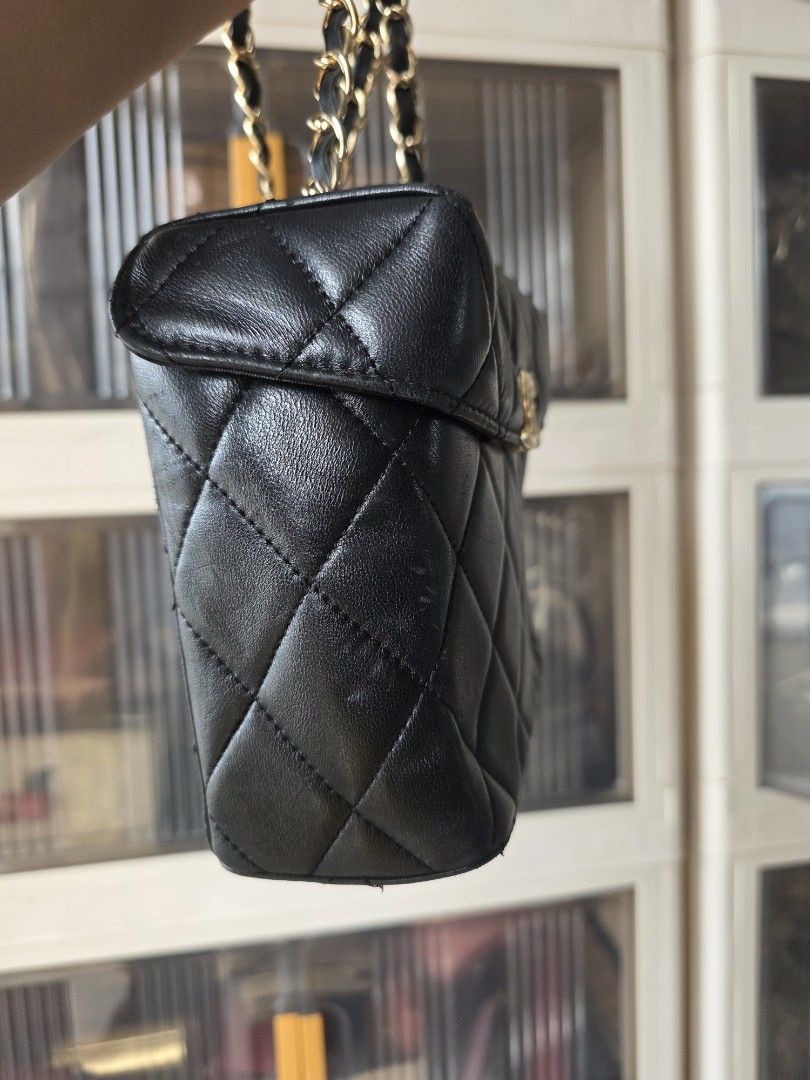 Chanel Black Quilted Vanity Bag Gold Hardware (Category: Luxury Bags & Wallets) located in Lemery. Submitted by venus23 (Listing ID 1467176767, Image 3). Description: -Chanel black quilted vanity bag - Classic diamond quilted leather with gold-tone hardware - Iconic interlocking CC logo on the front - Intertwined leather and gold chain strap - Structured boxy shape with 4 protective metal feet - Convenient external back slip pocket - Secure zippe