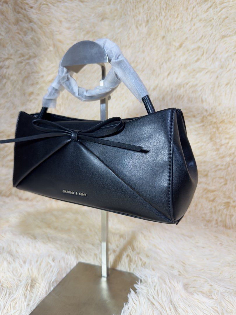 Charles & Keith Black Ribbon Tote Bag (Category: Tote Bags) located in Caloocan City. Submitted by hirahira.co (Listing ID 1467285725, Image 2). Description: - Brand: Charles & Keith - Color: Taupe / Neutral - Style: Structured tote bag - Features: Spacious interior, zipped compartments, top handles - Condition: Excellent, well-maintained - Perfect for daily commute, office, or casual outings.