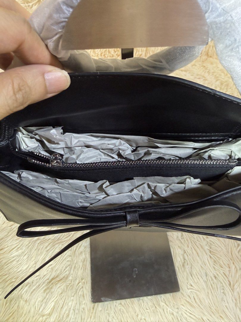 Charles & Keith Black Ribbon Tote Bag (Category: Tote Bags) located in Caloocan City. Submitted by hirahira.co (Listing ID 1467285725, Image 3). Description: - Brand: Charles & Keith - Color: Taupe / Neutral - Style: Structured tote bag - Features: Spacious interior, zipped compartments, top handles - Condition: Excellent, well-maintained - Perfect for daily commute, office, or casual outings.