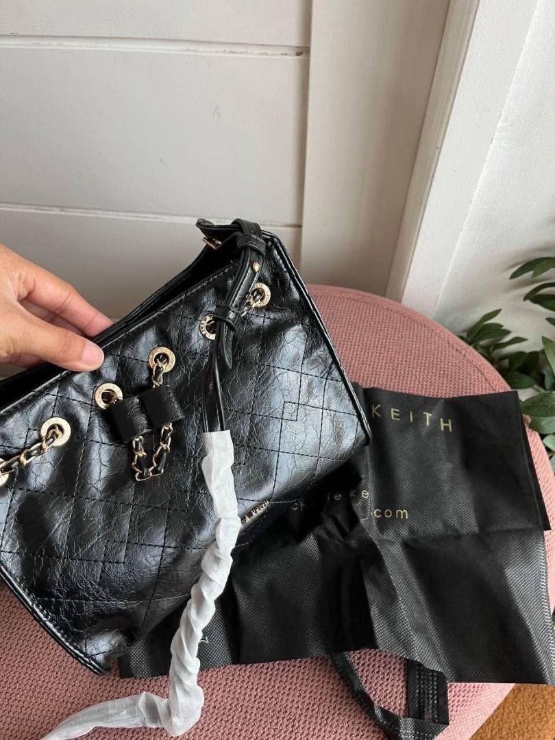 Charles & Keith Quilted Black Chain Bag (Category: Luxury Bags & Wallets) located in Valenzuela. Submitted by sv072724 (Listing ID 1467192578, Image 2). Description: - Brand: Charles & Keith - Color: Classic Black with chic gold-tone chain hardware - Design: Quilted finish with a delicate front bow detail - Closure: Secure top magnetic snap closure - Interior: Clean black fabric lining - Condition: Immaculate, clean inside and out - Inclusions: C