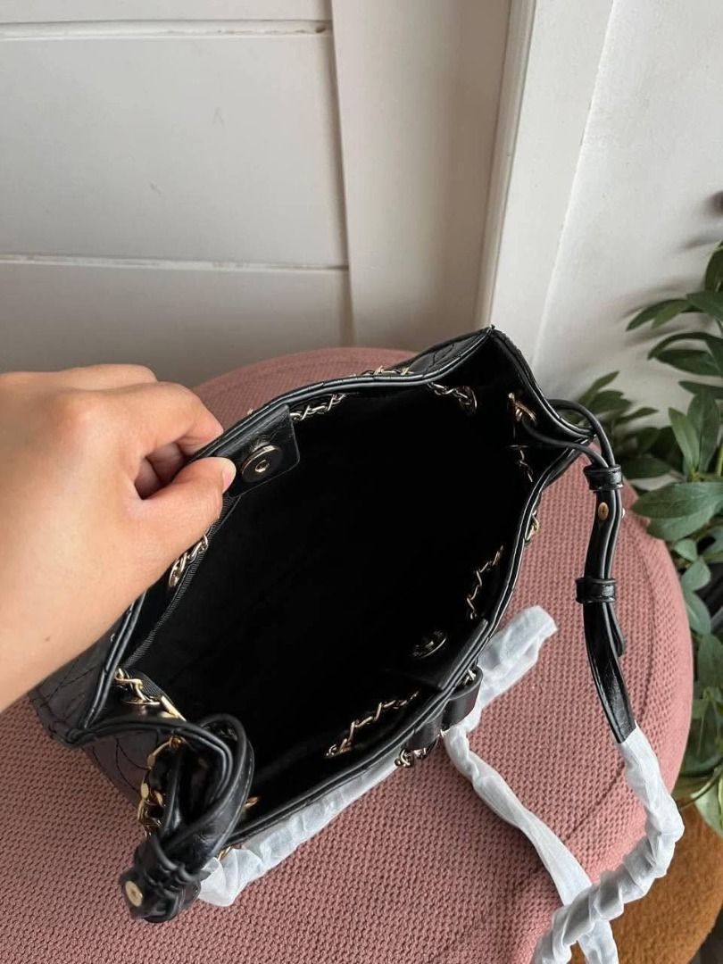 Charles & Keith Quilted Black Chain Bag (Category: Luxury Bags & Wallets) located in Valenzuela. Submitted by sv072724 (Listing ID 1467192578, Image 3). Description: - Brand: Charles & Keith - Color: Classic Black with chic gold-tone chain hardware - Design: Quilted finish with a delicate front bow detail - Closure: Secure top magnetic snap closure - Interior: Clean black fabric lining - Condition: Immaculate, clean inside and out - Inclusions: C