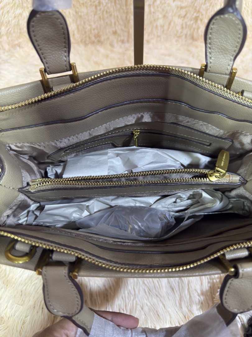 Charles & Keith taupe structured tote bag (Category: Tote Bags) located in Caloocan City. Submitted by hirahira.co (Listing ID 1467285701, Image 3). Description: - Brand: Charles & Keith - Style: Black Ribbon Tote Bag / Handbag - Color: Classic Black - Features: Elegant front ribbon detail, top carry handles with protective wrapping, secure interior zippered pocket - Condition: Brand new, pristine condition - Versatile design suitable for casual 