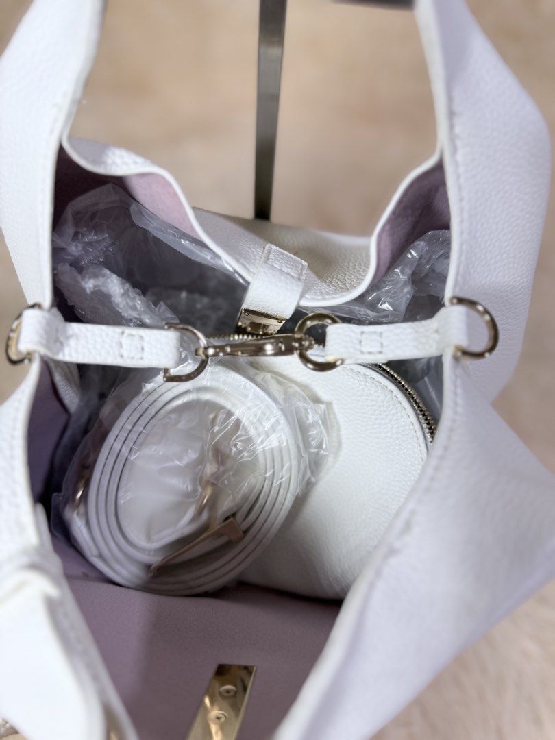 Charles & Keith White Shoulder Bag (Category: Shoulder Bags) located in Caloocan City. Submitted by hirahira.co (Listing ID 1467289371, Image 3). Description: - Brand: Charles & Keith - Color: Elegant white with light pink interior lining - Material: Premium textured faux leather - Hardware: Gold-tone front center closure - Inclusions: Matching white shoulder strap and removable small inner pouch - Condition: Brand new with original dust packing 