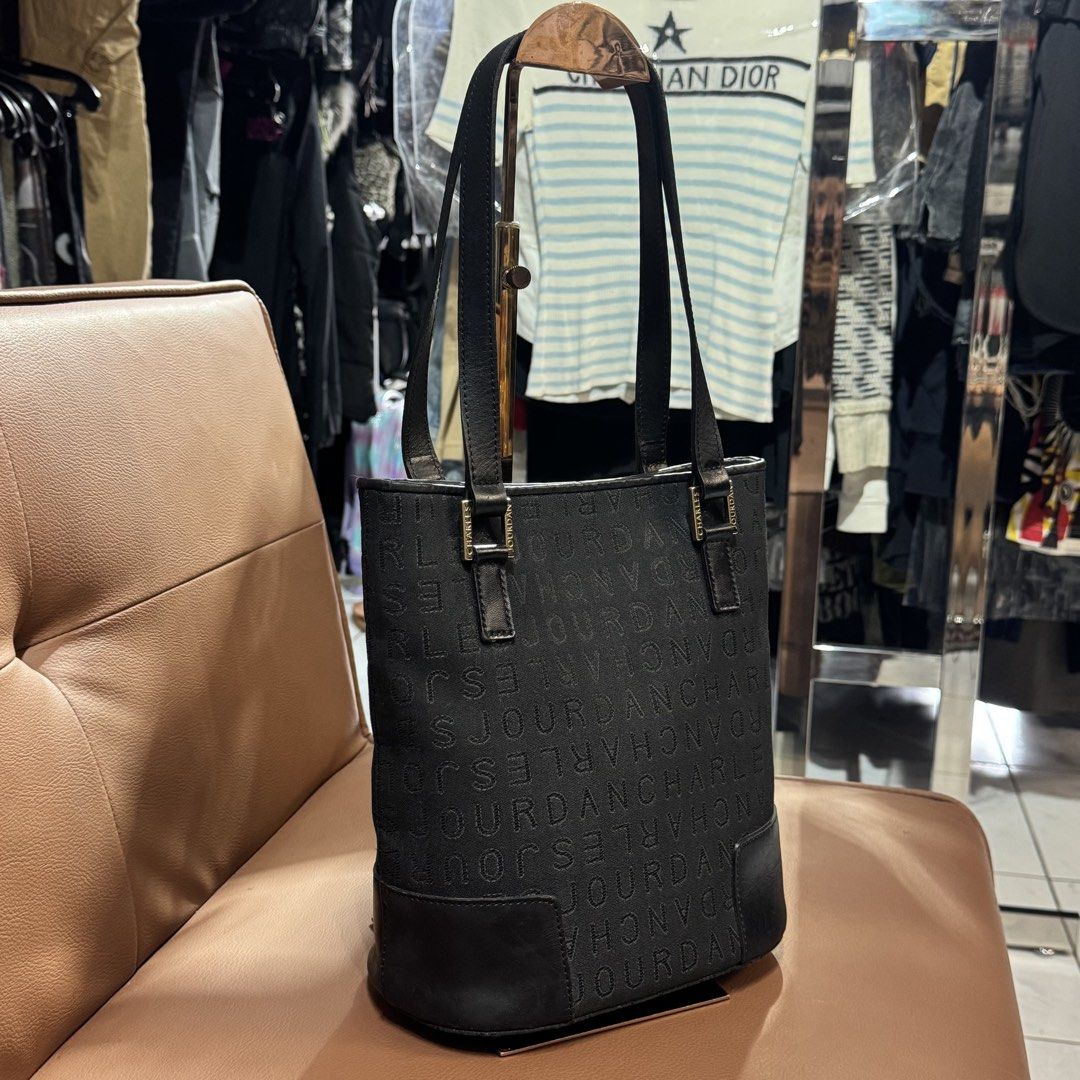 Charles Jourdan bucket tote bag (Category: Tote Bags) located in Rizal. Submitted by houseofbell (Listing ID 1467361571, Image 2). Description: - Brand: Charles Jourdan - Color: Classic black with all-over monogram print - Material: Durable monogram fabric with a sturdy leather base - Closure: Secure top magnetic snap Dimension 9x10 inches .
