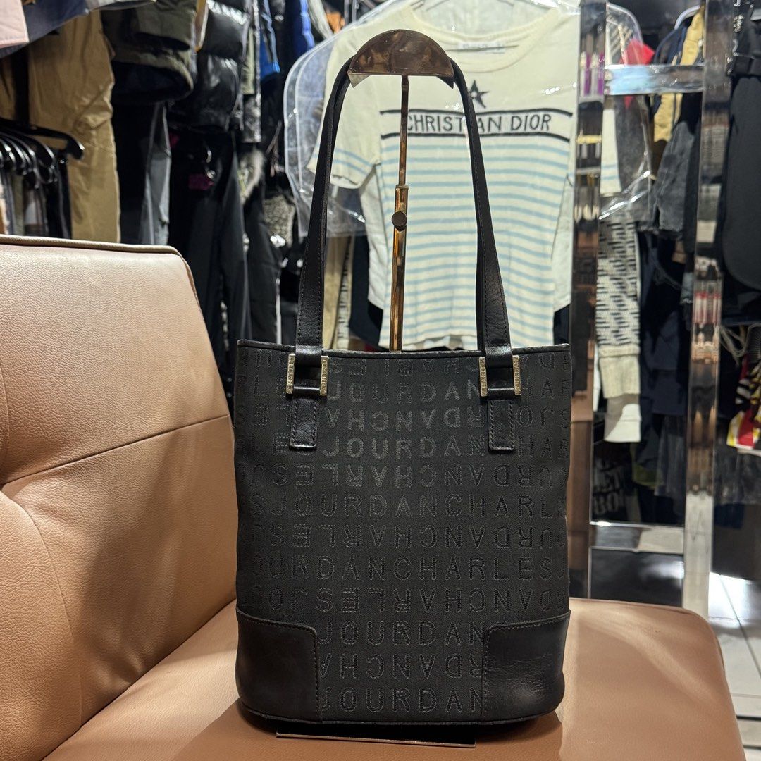 Charles Jourdan bucket tote bag (Category: Tote Bags) located in Rizal. Submitted by houseofbell (Listing ID 1467361571, Image 1). Description: - Brand: Charles Jourdan - Color: Classic black with all-over monogram print - Material: Durable monogram fabric with a sturdy leather base - Closure: Secure top magnetic snap Dimension 9x10 inches .