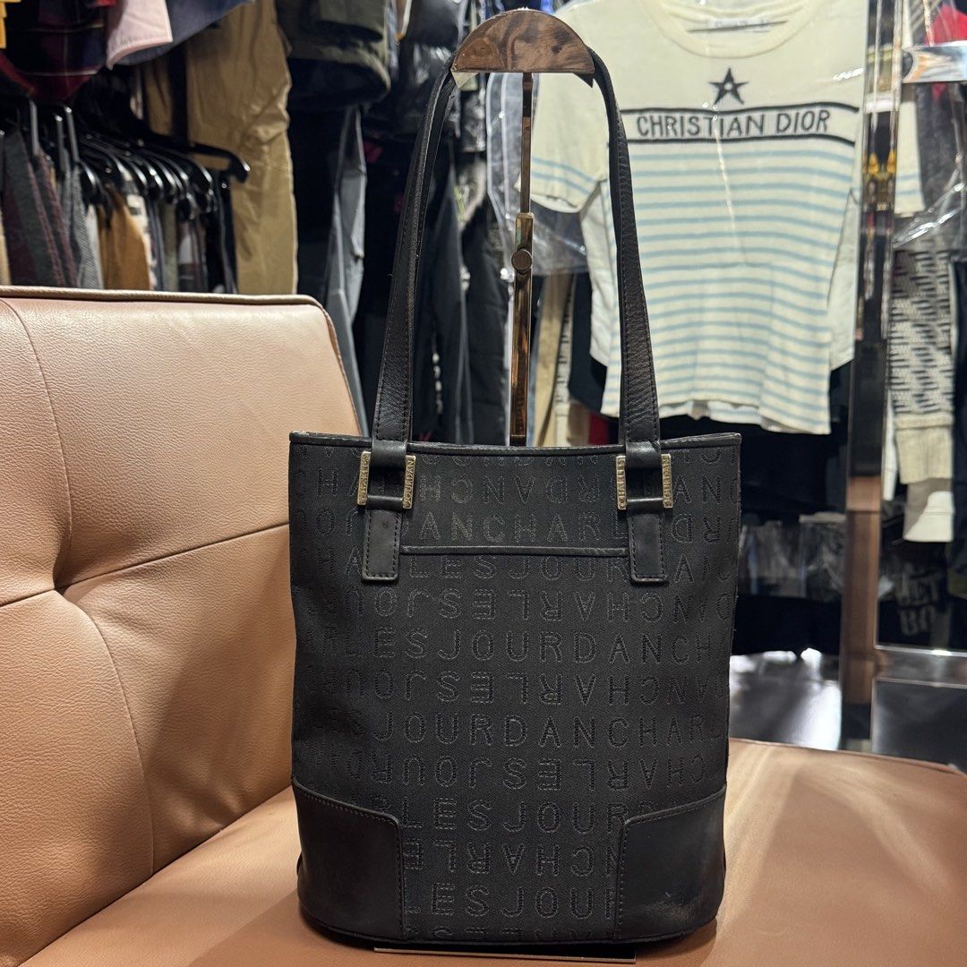 Charles Jourdan bucket tote bag (Category: Tote Bags) located in Rizal. Submitted by houseofbell (Listing ID 1467361571, Image 3). Description: - Brand: Charles Jourdan - Color: Classic black with all-over monogram print - Material: Durable monogram fabric with a sturdy leather base - Closure: Secure top magnetic snap Dimension 9x10 inches .