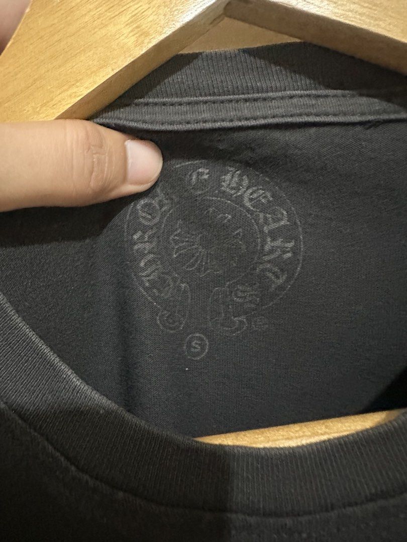 Chrome Hearts Pocket T-Shirt Black (Category: Tshirts & Polo Shirts ) located in Tagum. Submitted by ritarits572 (Listing ID 1467289936, Image 3). Description: - Brand: Chrome Hearts - Item: Black Pocket T-Shirt - Size: Small, 17 x 26.5 - Details: Cross graphics on back and lower front, gothic logo script on chest pocket - Material: Heavy cotton jersey with a stylish faded black wash - Authenticity: Includes inside collar print, woven brand tag, 