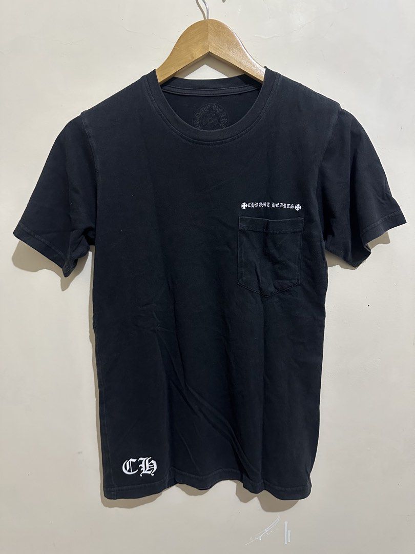 Chrome Hearts Pocket T-Shirt Black (Category: Tshirts & Polo Shirts ) located in Tagum. Submitted by ritarits572 (Listing ID 1467289936, Image 1). Description: - Brand: Chrome Hearts - Item: Black Pocket T-Shirt - Size: Small, 17 x 26.5 - Details: Cross graphics on back and lower front, gothic logo script on chest pocket - Material: Heavy cotton jersey with a stylish faded black wash - Authenticity: Includes inside collar print, woven brand tag, 