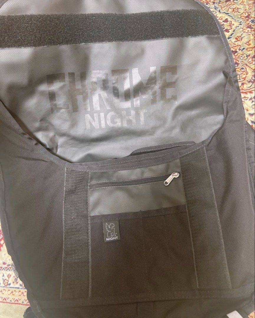 Chrome Industries Night Series Messenger Bag (Category: Sling Bags) located in Calamba. Submitted by youngraven (Listing ID 1467200311, Image 3). Description: - Brand: Chrome (Night Series) - Color: Black - Material: Heavy-duty Cordura with waterproof tarpaulin lining - Features: Iconic seatbelt buckle closure with gryphon logo, reflective front stripes, multiple zippered organizer pockets - Origin: American made tag intact - Condition: Built to 