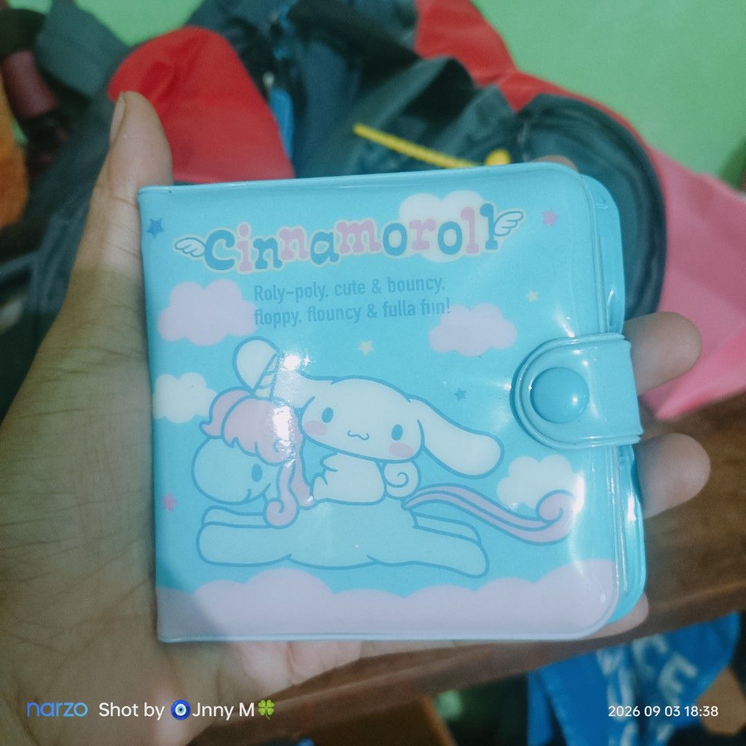 Cinnamoroll blue plastic wallet with coin pocket (Category: Wallets & Card holders) located in Taguig. Submitted by mhayestufftoys (Listing ID 1467352648, Image 1). Description: - Authentic Sanrio Cinnamoroll design in a sweet light blue color - Front graphic features Cinnamoroll riding a magical unicorn with playful text - Secure snap button main closure - Convenient inner coin pouch with snap closure - Built-in ID card slot complete with name, 