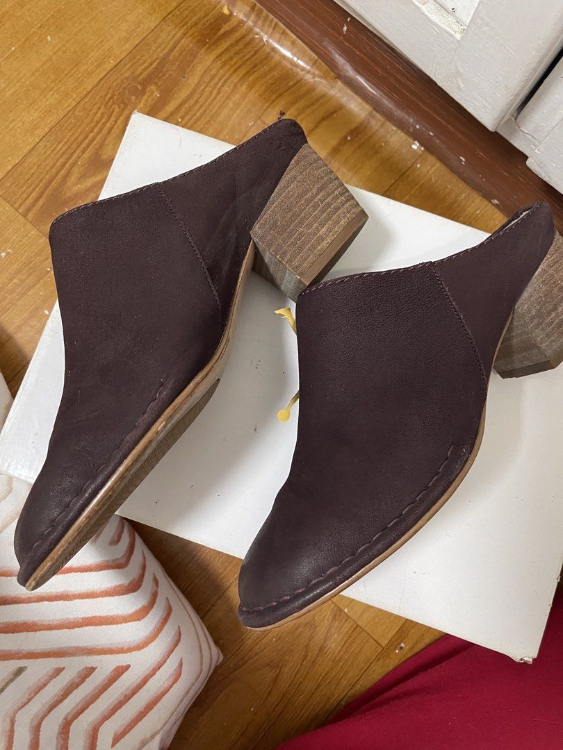 Clarks Cushion Plus Plum Suede Mules Block Heel (Category: Flats & Sandals) located in Taguig. Submitted by 1307maloc (Listing ID 1467214157, Image 2). Description: - Brand: Clarks - Style: Slip-on leather mules with rounded toe - Color: Plum - Heel: Wooden block heel - Comfort: Built-in Cushion technology - Condition: Uppers are clean and scuff-free; soles show light outdoor wear; footbeds have minor dust marks from storage.