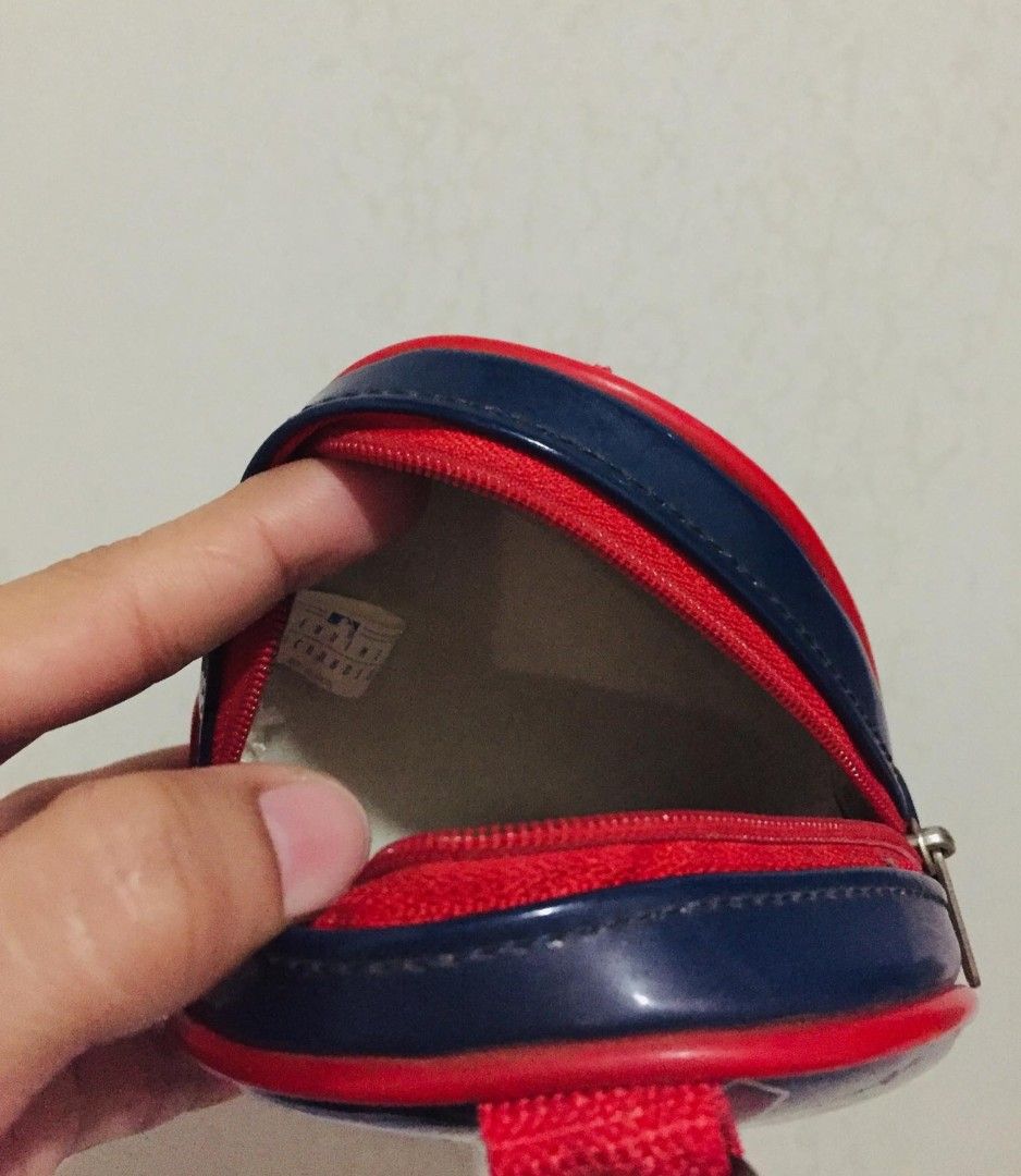 Cleveland Indians MLB Logo Triangular Zip Pouch (Category: Purses & Pouches) located in Batangas. Submitted by fabufindsstore. (Listing ID 1467294988, Image 2). Description: MLB Cleveland Indians zip pouch Quality material Navy blue and red triangular glossy pouch Features iconic Chief Wahoo logo and script graphics Red zipper closure with a top hanging loop Clean white interior lining with official tag Compact size, ideal for coins, keys, and sm