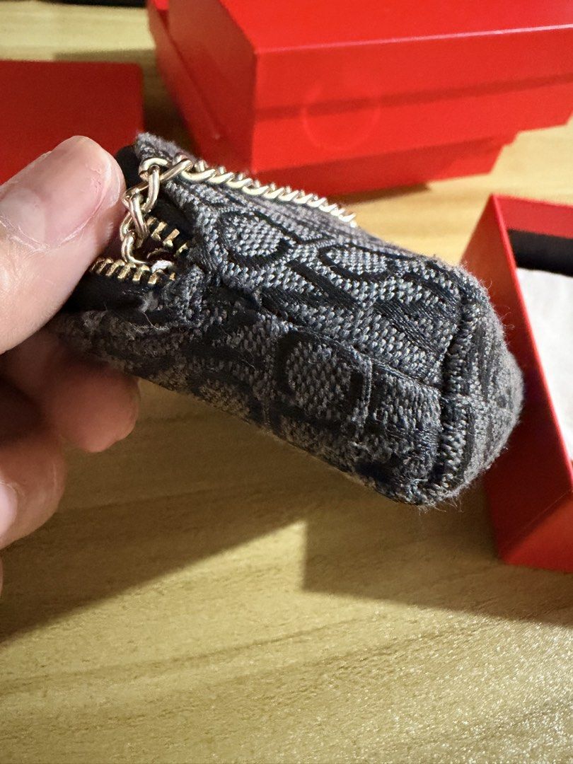 CLN Monogram Coin Purse with Keychain (Category: Purses & Pouches) located in San Juan City. Submitted by thisismeely (Listing ID 1467169079, Image 3). Description: - Brand: CLN - Color: Charcoal grey with stylish monogram print - Hardware: Premium gold-toned hardware - Closure: Secure zip-around design - Interior: Satin lining with monogram print, attached key ring, and chain - Inclusion: Comes with original red CLN branded box.