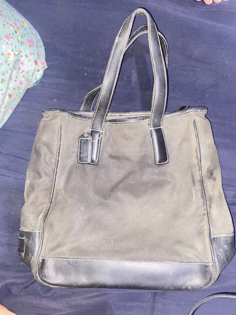 Coach Black Tote Bag B0K-7708 (Category: Luxury Bags & Wallets) located in Manila. Submitted by togekimiwa (Listing ID 1467327608, Image 2). Description: - Brand: Coach - Color: Black - Material: Durable fabric with leather trim - Features: Dual handles, secure zip-top main compartment, original hangtag, and interior creed patch with serial number (B0K-7708) - Condition: Visible wear throughout the exterior and leather accents, with a noticeable 