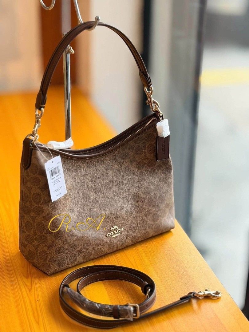 Coach Brown Signature Canvas Shoulder Bag (Category: Luxury Bags & Wallets) located in Manila. Submitted by rhona30antiquera (Listing ID 1467229712, Image 1). Description: - Authentic Coach brown signature canvas shoulder bag - Elegant gold-tone hardware with dark brown trim - Secure zip-top closure - Includes a detachable leather strap for versatile cross-body wear - Signature hangtag attached.